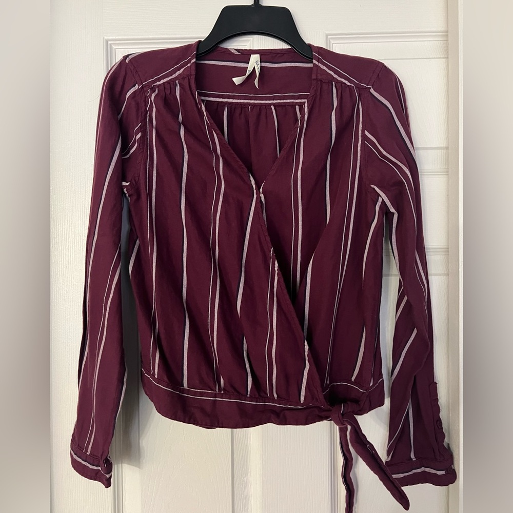 Maroon long-sleeved wrap blouse, with tie bottom at hip